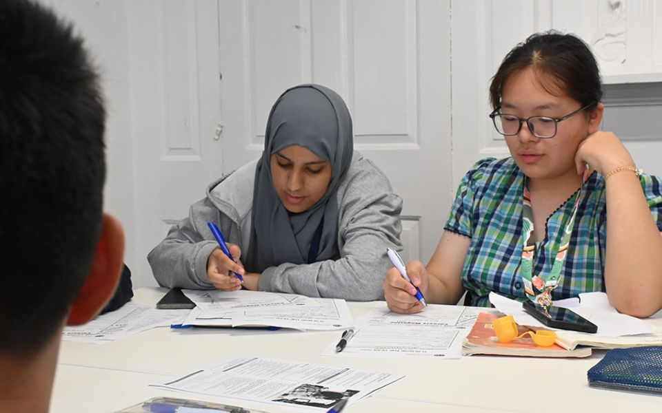 Two young women study in classroom