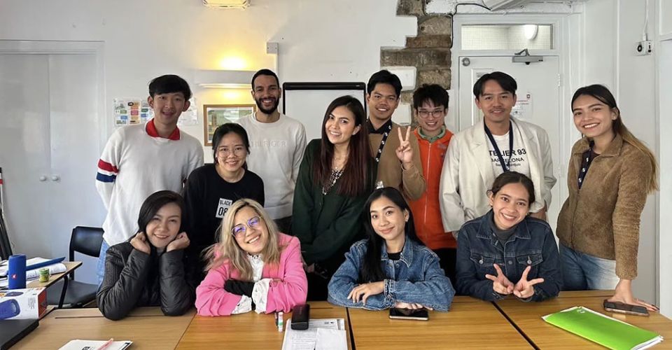 Students in classroom pose for photo