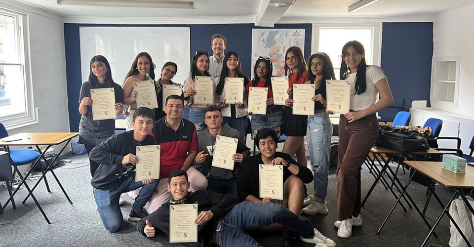 students with certificates pose for group photo